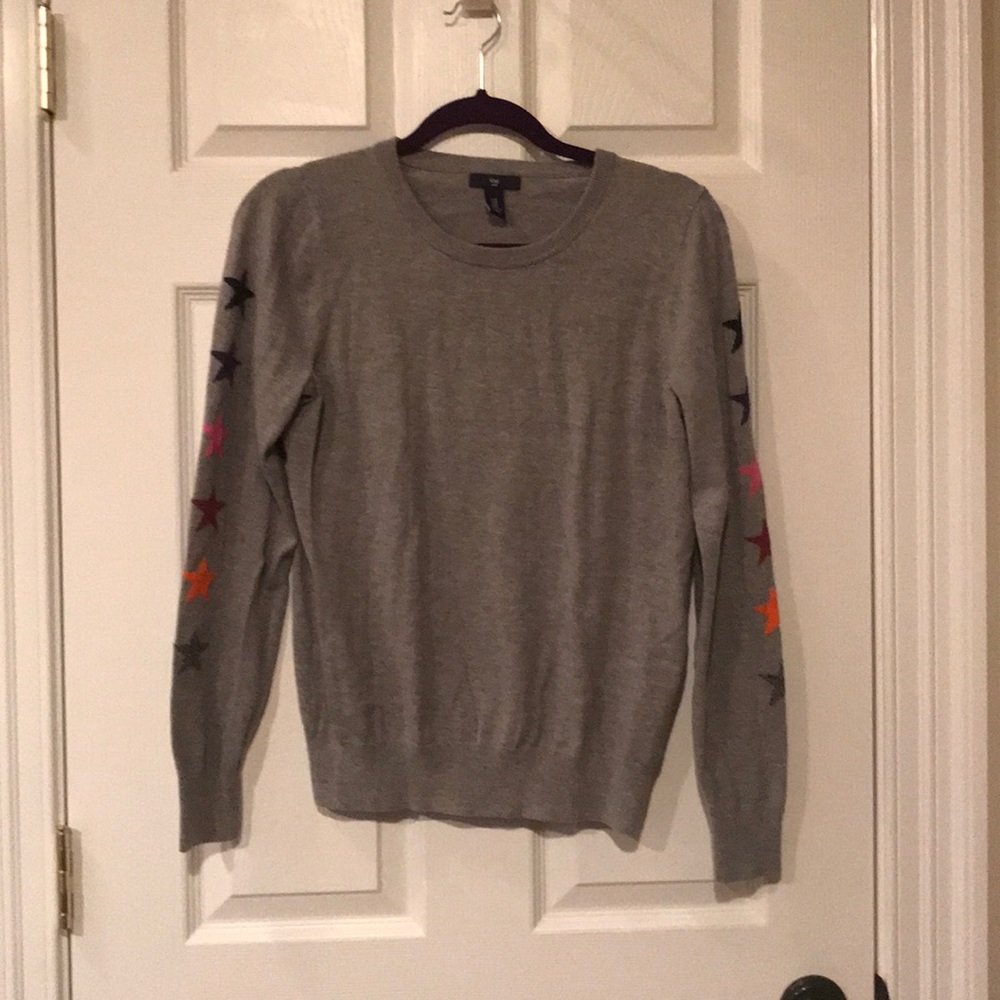 Grey sweater with stars.